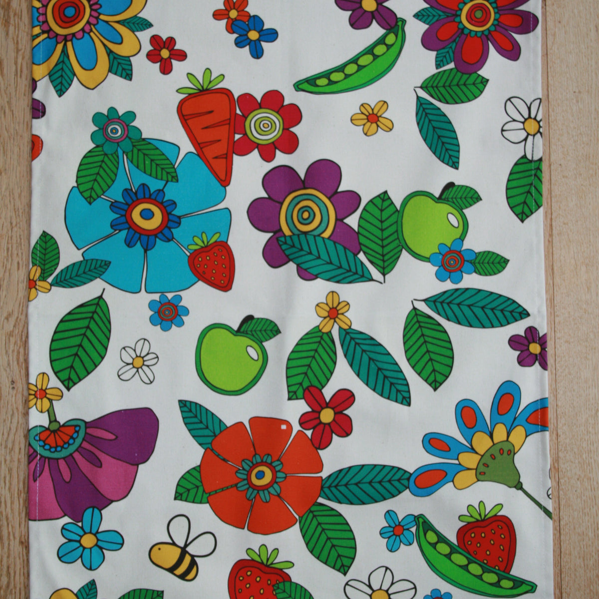 Natural Grower organic cotton tea towel with colourful Flower Power garden design