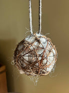 20cm sheep's wool nesting ball with dark woven willow and braided hanging handle