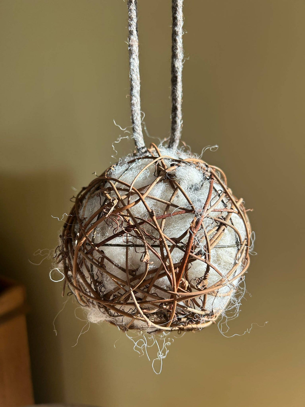 20cm sheep's wool nesting ball with dark woven willow and braided hanging handle