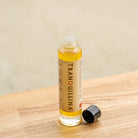 Open bottle of TranQuillina Organic Calendula Oil showing golden botanical oil