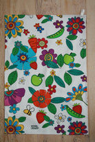 Natural Grower organic cotton tea towel with colourful Flower Power garden design